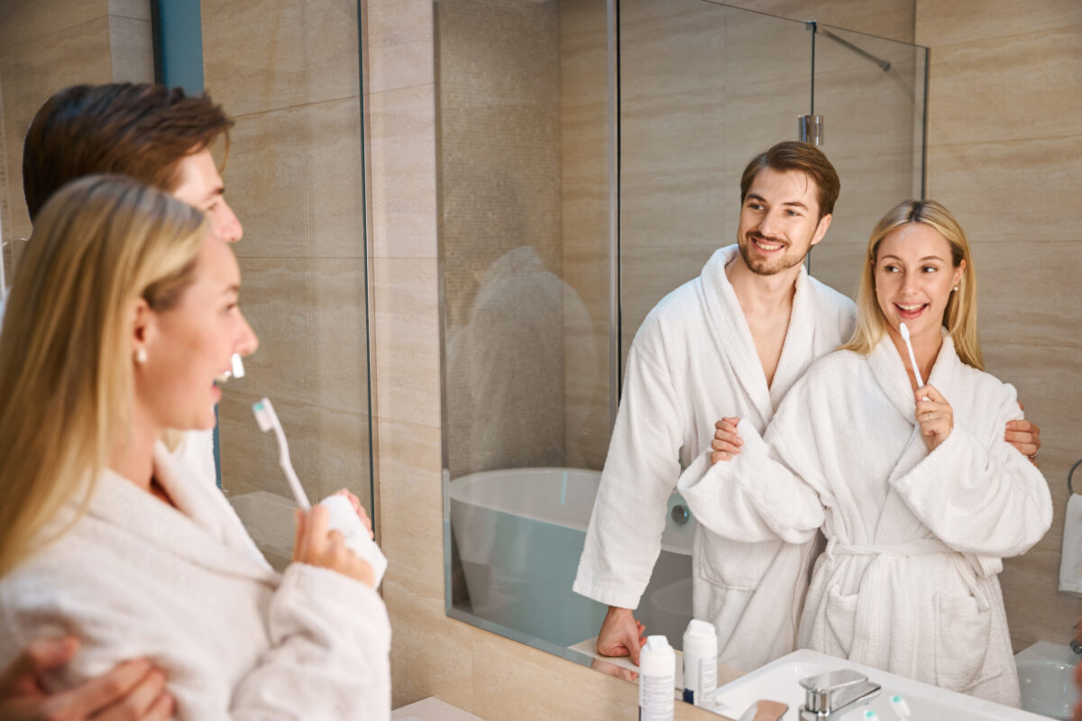 Young husband and wife in bathroom doing their morning routine