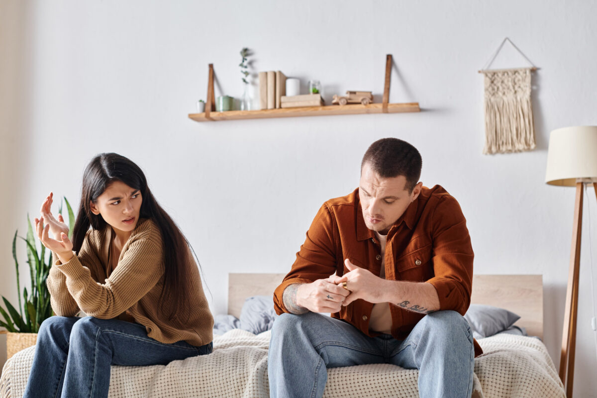 10 Signs Your Relationship Might Be a Rebound And How to Tell 3 frustrated multiethnic couple sitting and quarrelling in bedroom at home, divorce concept