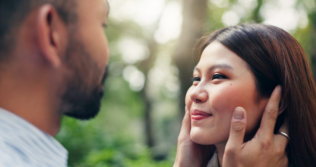 Japan, outdoor and couple with love, care and bonding together with relationship. Romance, man and woman in park, trust and marriage with nature, travel and commitment with weekend break and joyful