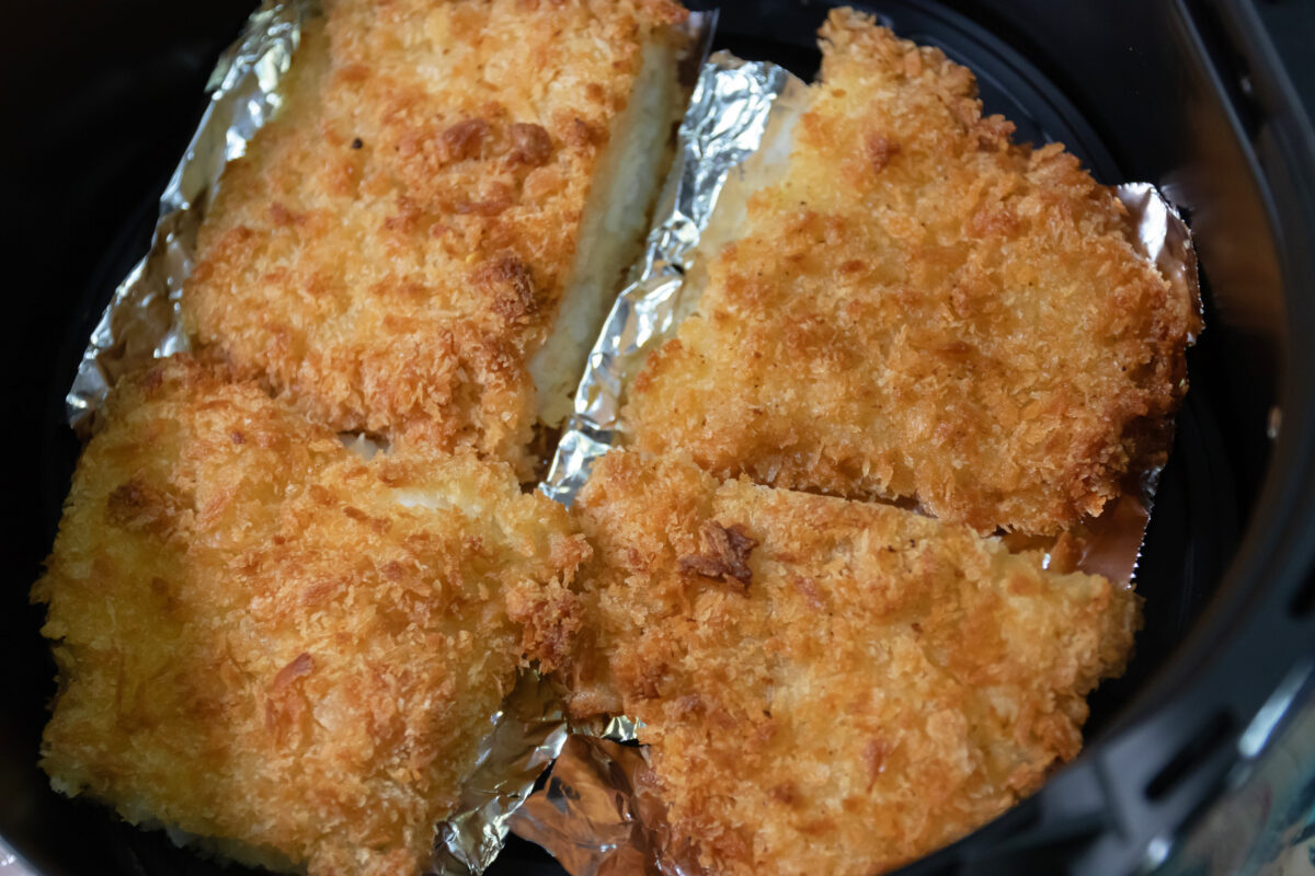 Crispy fried fish fillets in an air fryer, showcasing golden-brown crust and delicious flavor, perfect for healthy meals.
