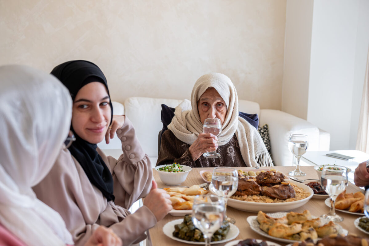 Family eating together with multi generation members in modern living room