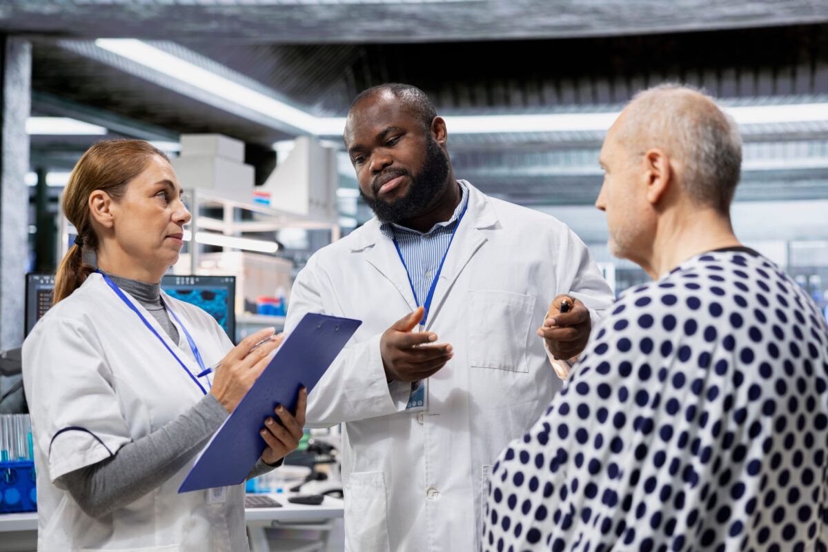 Medical researchers conducting patient evaluation in a laboratory drug study, collecting data on treatment outcomes and side effects, supporting toxicology and immunology research.