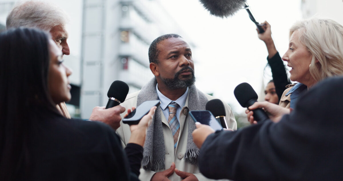 Politician, man and interview with journalist for election announcement, campaign opinion or reaction. Political leader, people and media in city for qna discussion, question and mayor vote feedback.