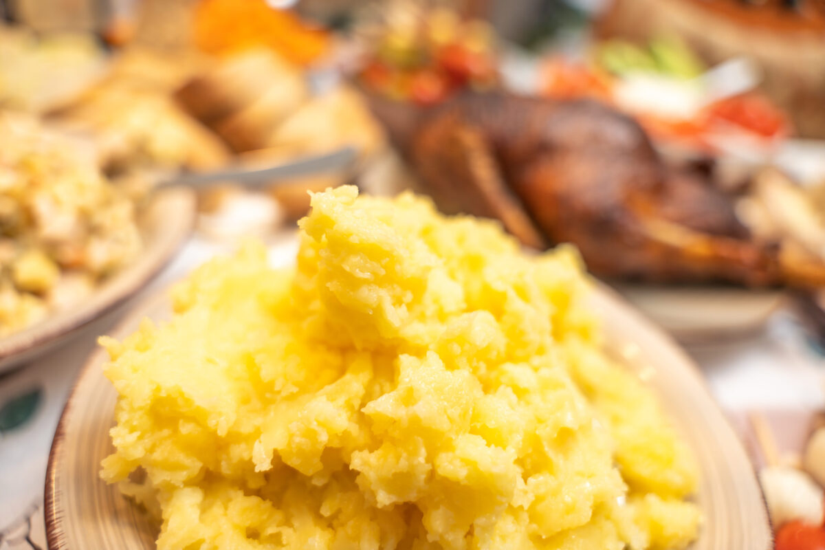 10 Things You Should Never Put in a Blender 1 Mashed potatoes with food in background. Creamy mashed potatoes served on a plate with traditional food in the background. Comfort food scene highlighting homemade cooking and warm meal atmosphere.