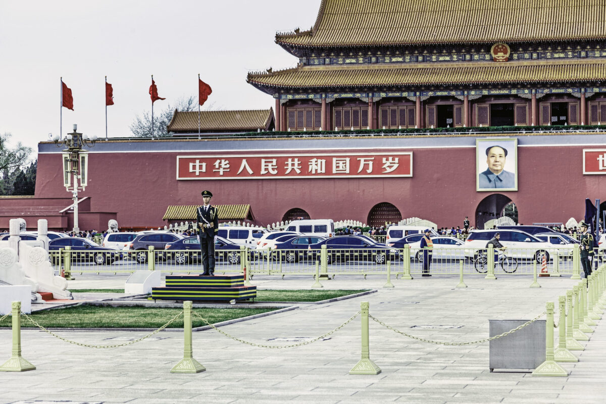 A view on the Forbidden City and the  guards of the flag of China with its from the Tiananmen Square in Beijing, China - April 16, 2015
