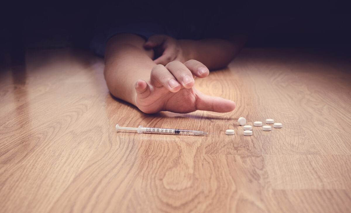 overdose male drug addict hand, drugs narcotic syringe on floor