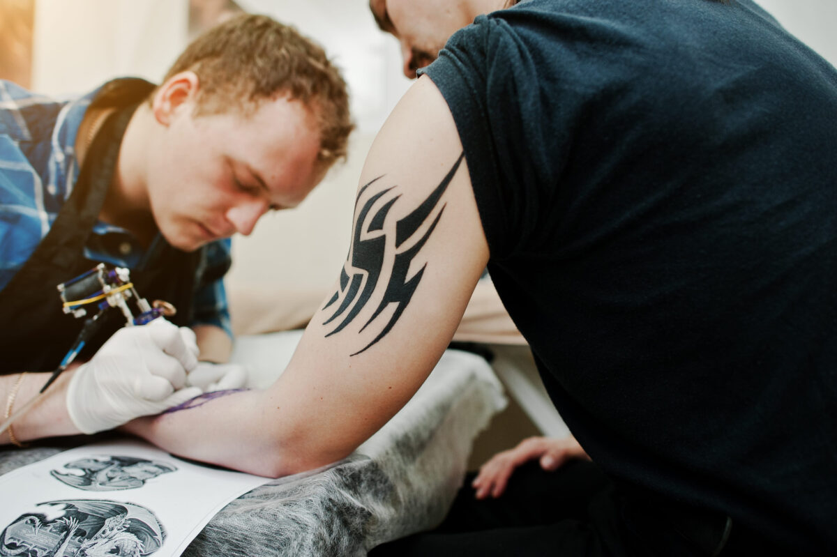 10 Worst Tattoos People Regret Having 4 Tattoo master make tattoo for rocker man at tattoo salon