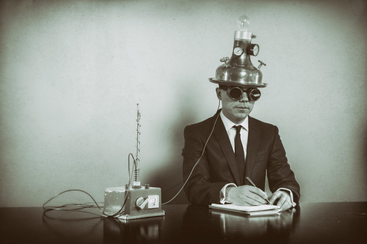 Businessman sitting at office desk with vintage goggles