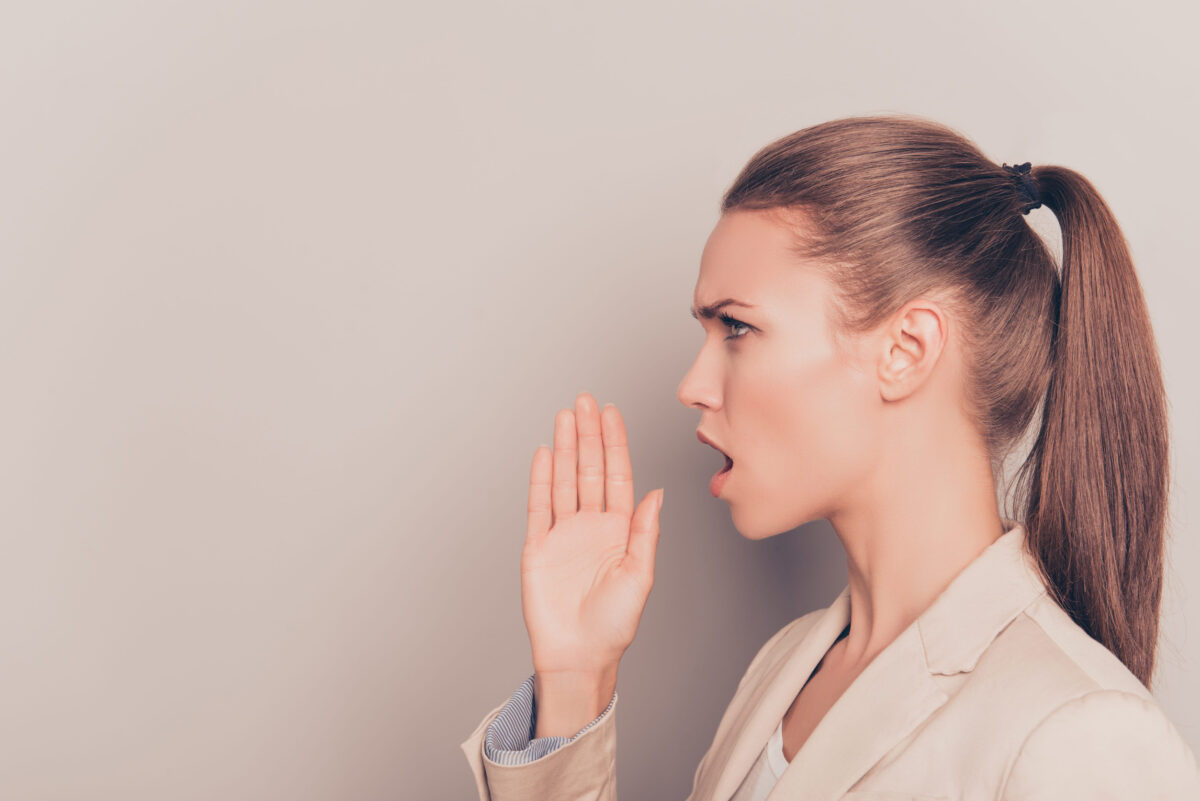 Side view of young businesswoman making important announcement