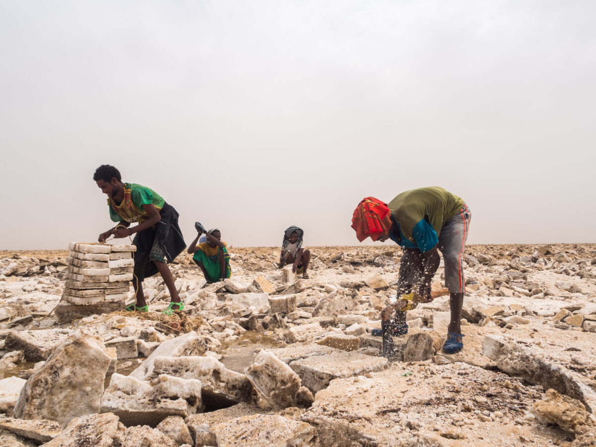 DANAKIL DEPRESSION, ETHIOPIA - JUNE 29, 2016: Afar men mining salt from salt flats in Afar region, Danakil Depression, Ethiopia.
