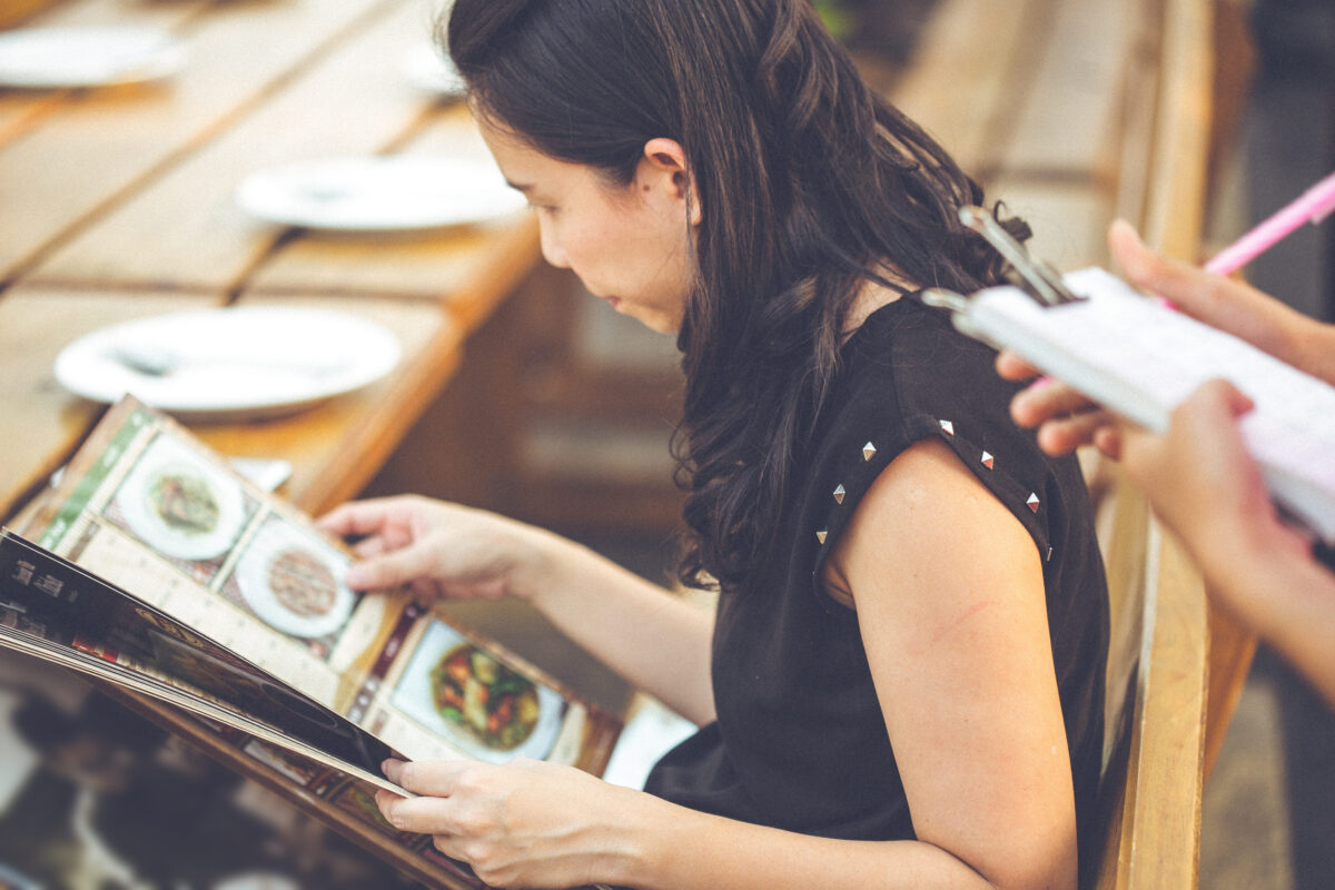 10 Restaurant Red Flags You Should Never Ignore 4 people looking menu waitress taking order restaurant