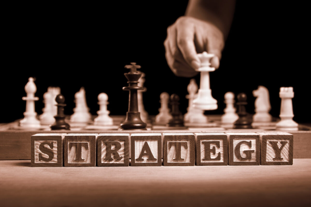 Word STRATEGY in front of chessboard