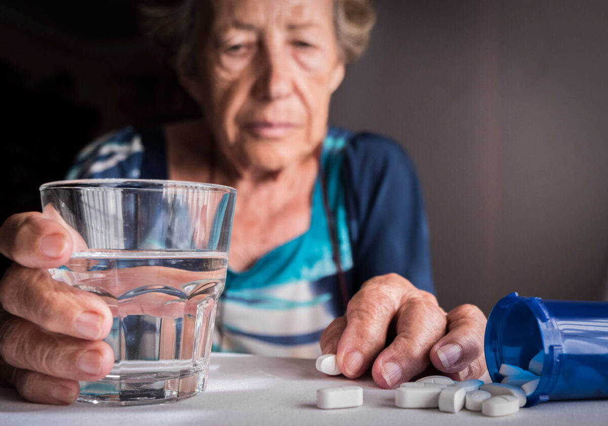 8 Shocking Truths About Alcohol and Aging 2 Oldster taking daily medication dose at home, Andalusia, Spain