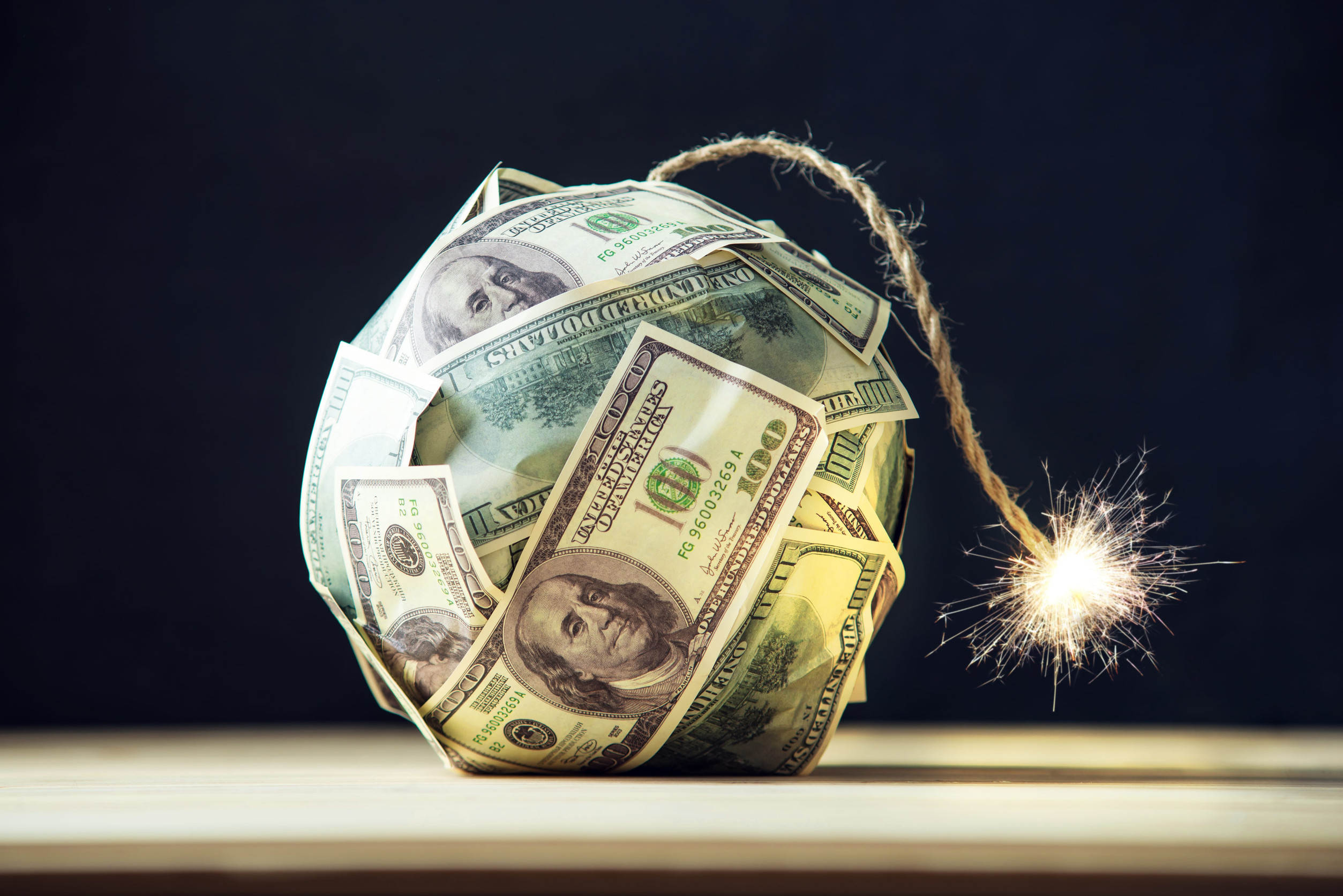 11 Brutal Dating Truths Pushing People Away From Love 3 Big bomb of money hundred dollar bills with a burning wick. Little time before the explosion. The concept of financial crisis