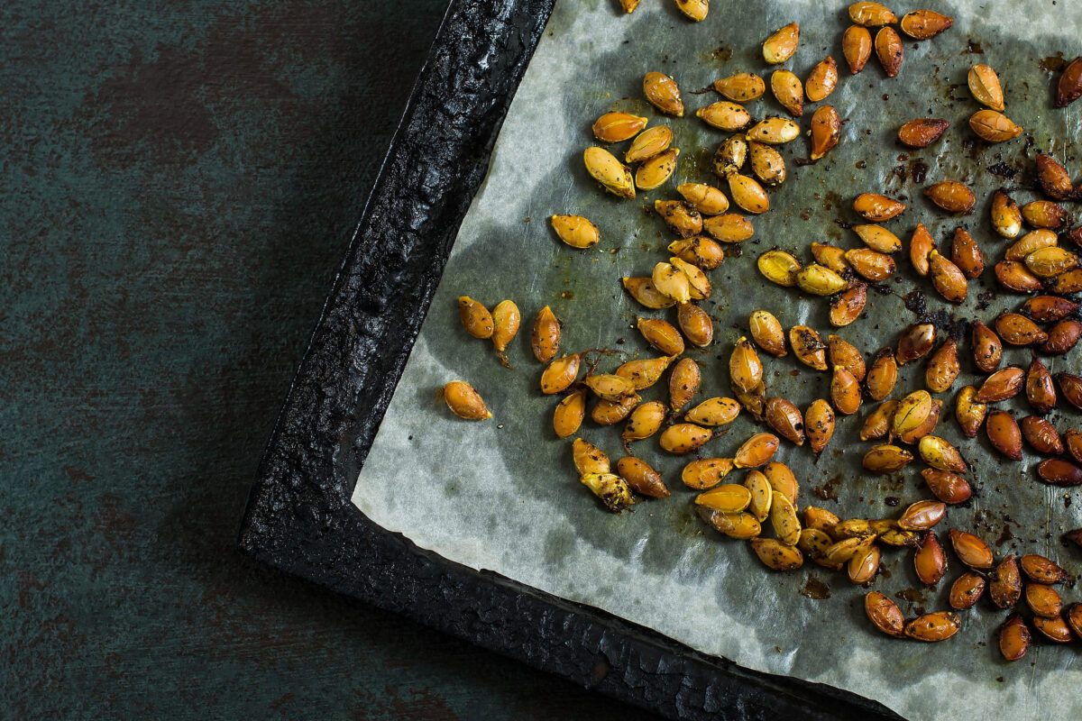 9 States With the Highest Pumpkin Spice Search Interest 2 Pumpkin seeds fried with spices on old iron baking sheet. Dark textured background, rustic style