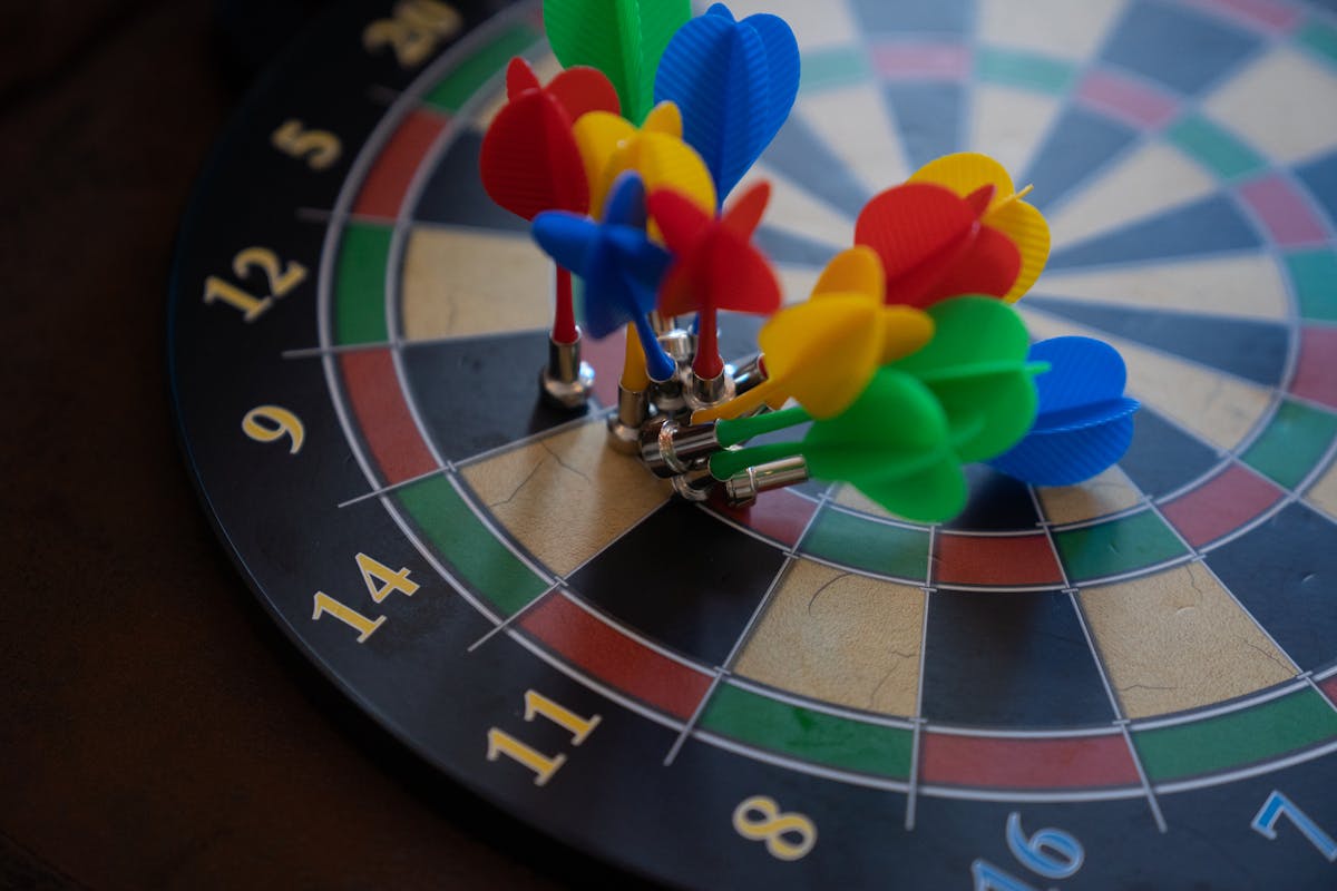 A close-up shot of colorful magnetic darts clustered on a dartboard, showcasing precision.