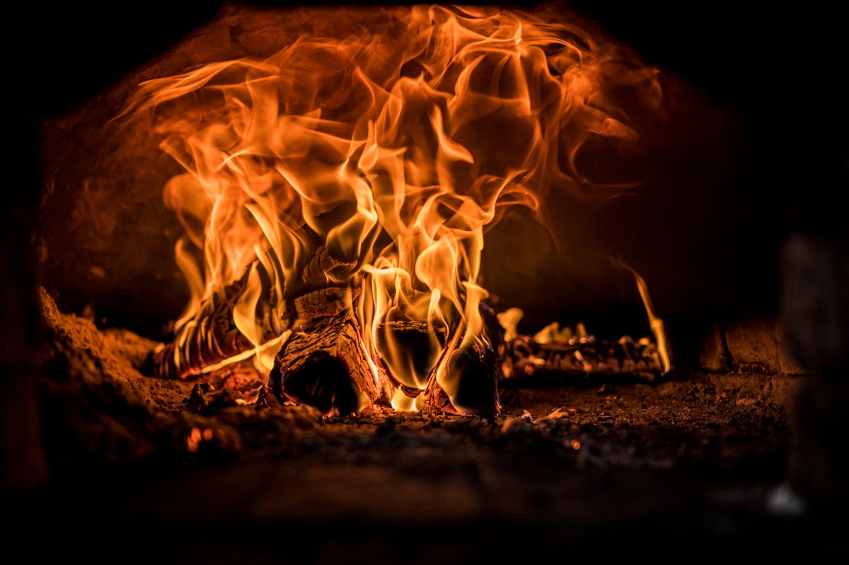 A close-up view of dancing flames in a cozy wood-fired oven.