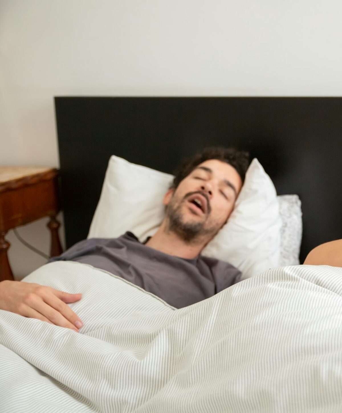 Could Snoring Be More Dangerous to Your Health Than You Think? 1 a man snoring while asleep