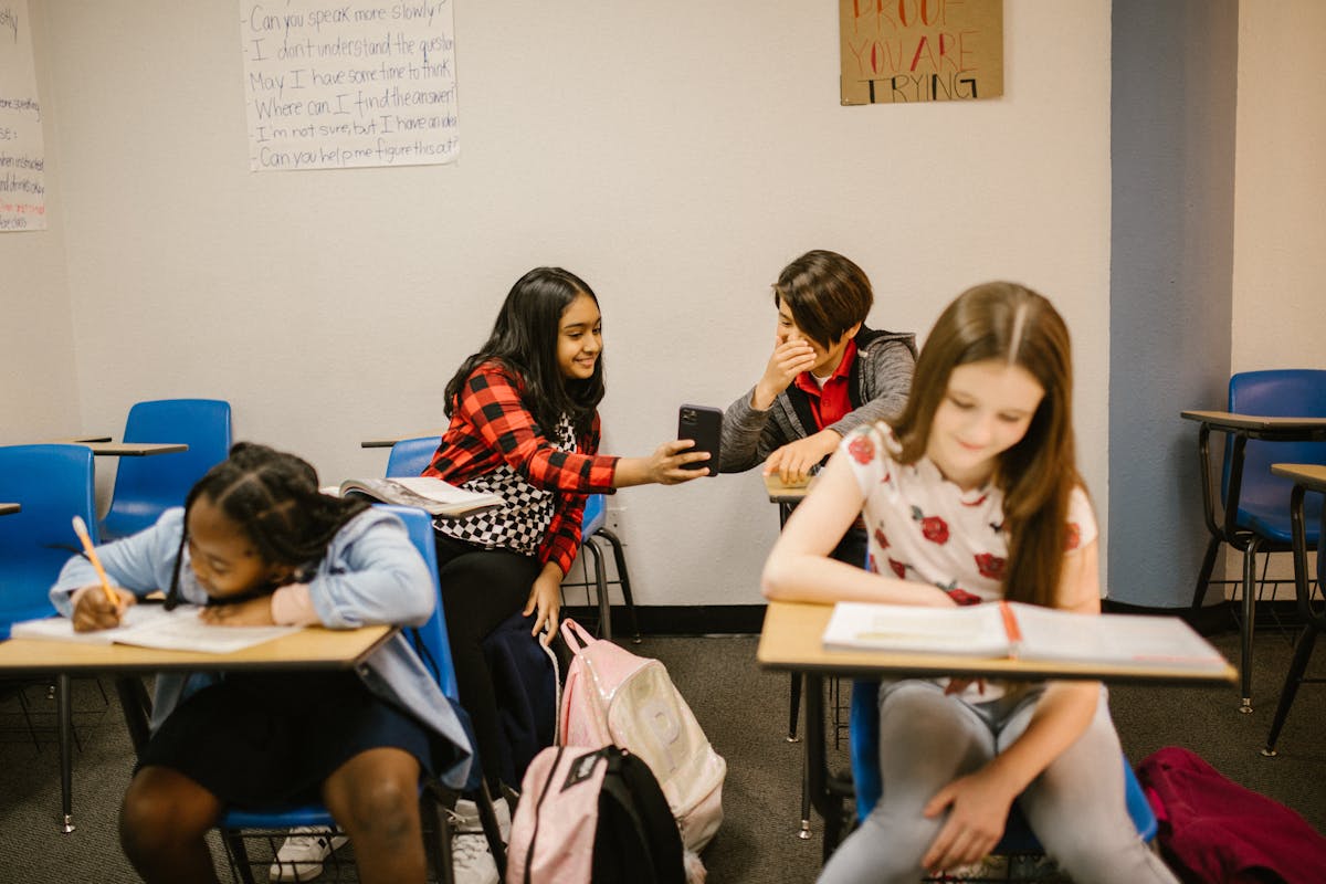 7 Alarming U.S. Culture Wars That Are Getting Harder to Ignore 1 A diverse group of children interacting and studying in a school classroom.