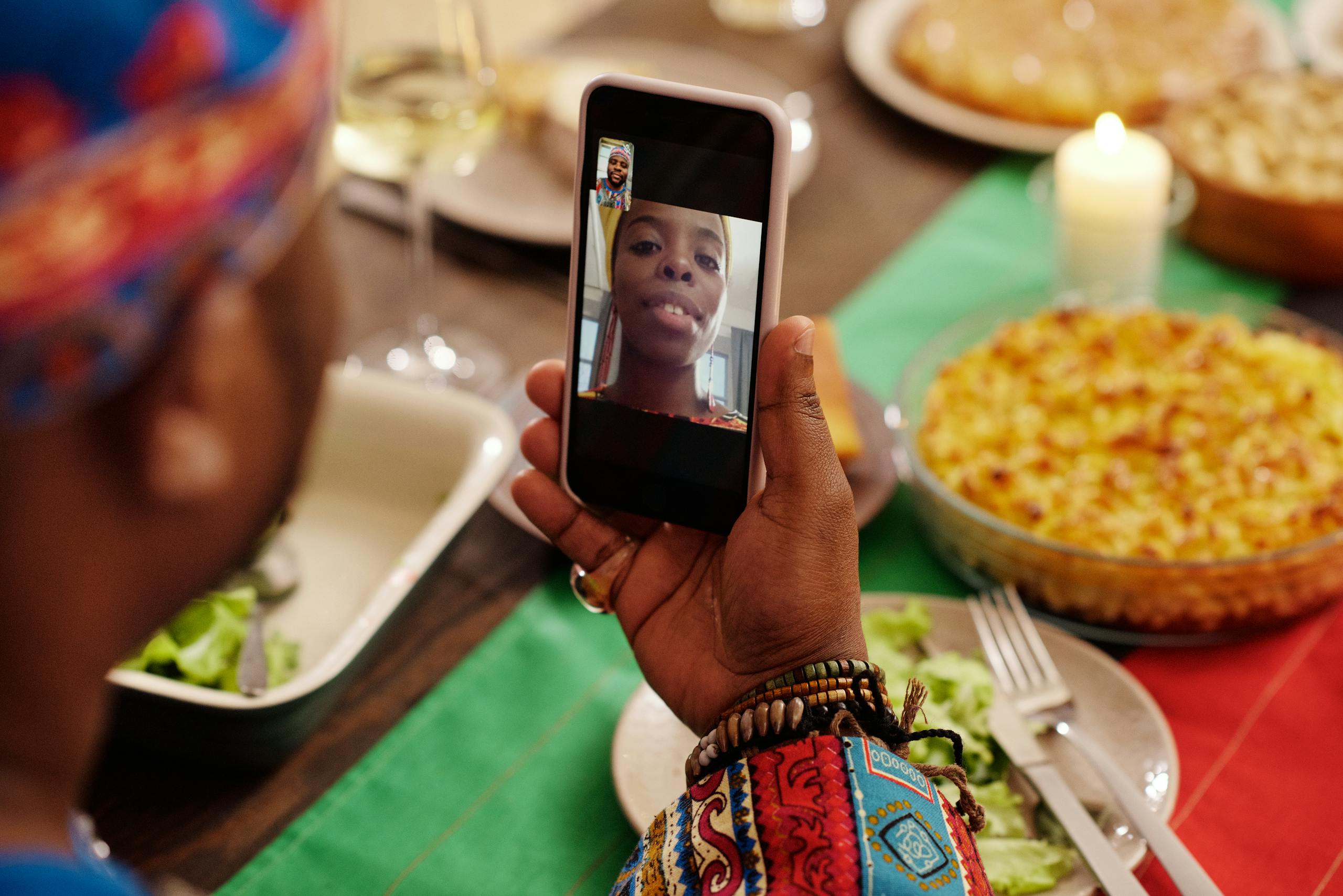 A family celebrates with a virtual dinner using video call technology, connecting loved ones remotely.