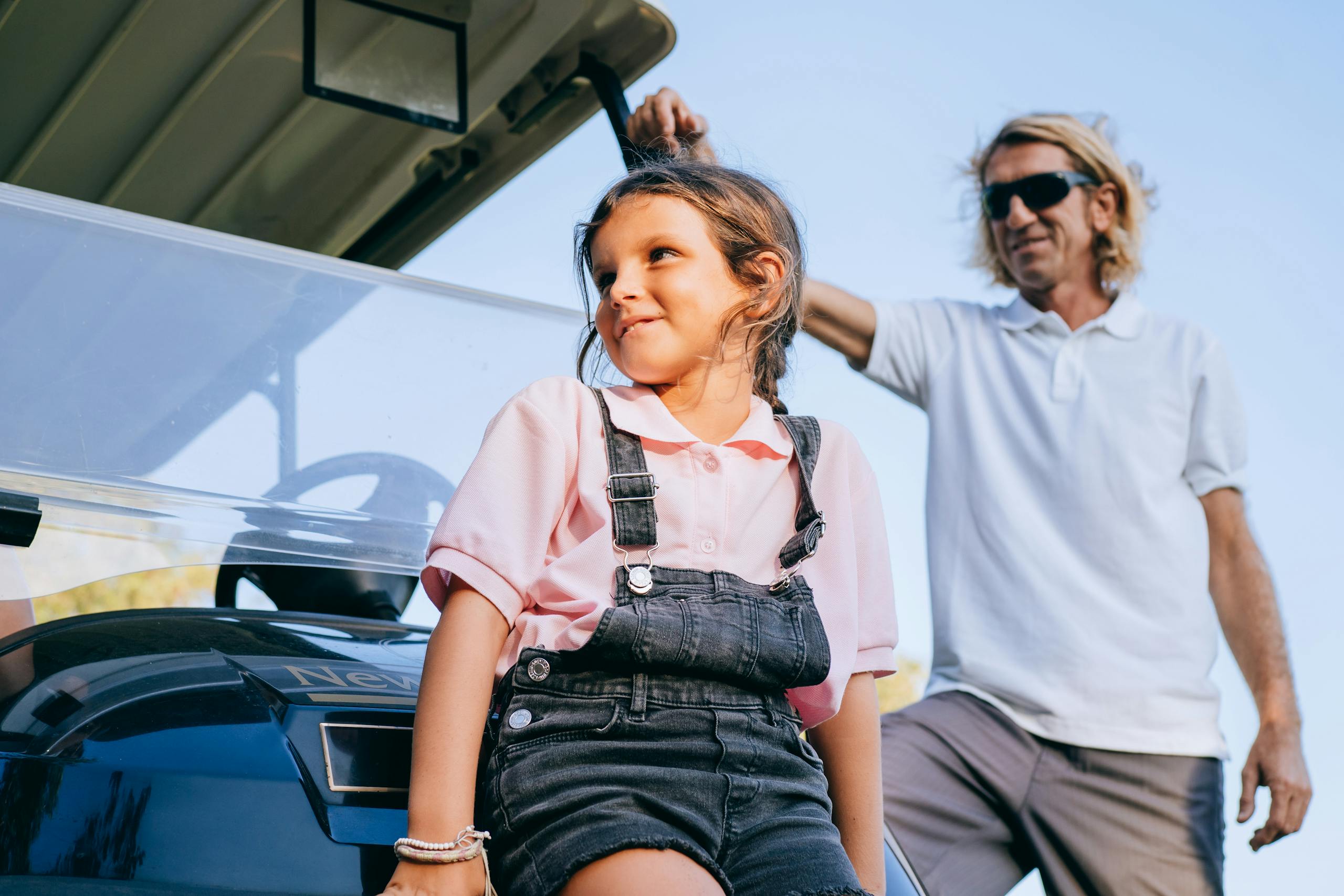 A joyful father and daughter spend quality time together on a sunny day.