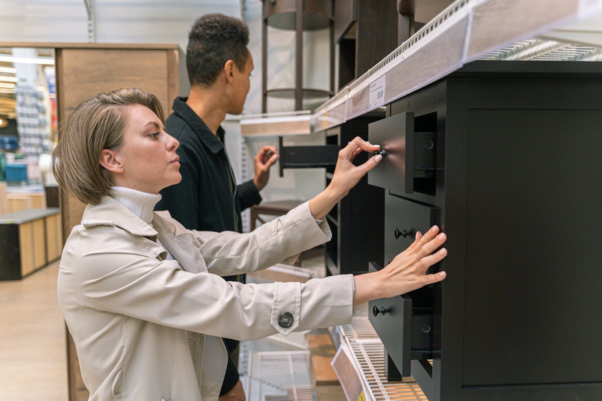 10 Reasons Home Depot Stock Is Falling to a New Low 3 A man and woman examining drawers in a furniture store, exploring options.