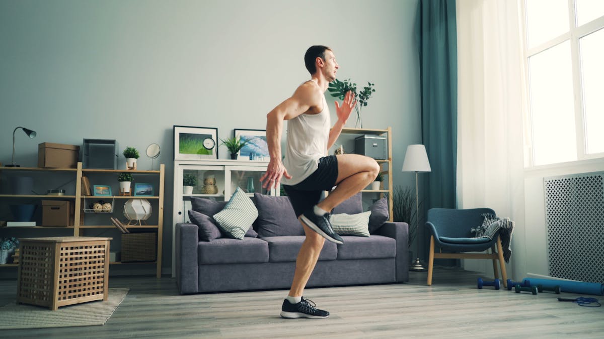 6 Self-Care Myths That Are Doing More Damage Than Most People Realize 2 A man in sportswear exercising indoors with a modern living room background.