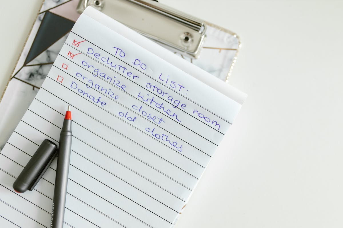 Home Maintenance Mistakes That Quietly Drain a Homeowner’s Budget 3 A neatly written to-do list on lined paper with a pen, perfect for organizing tasks.