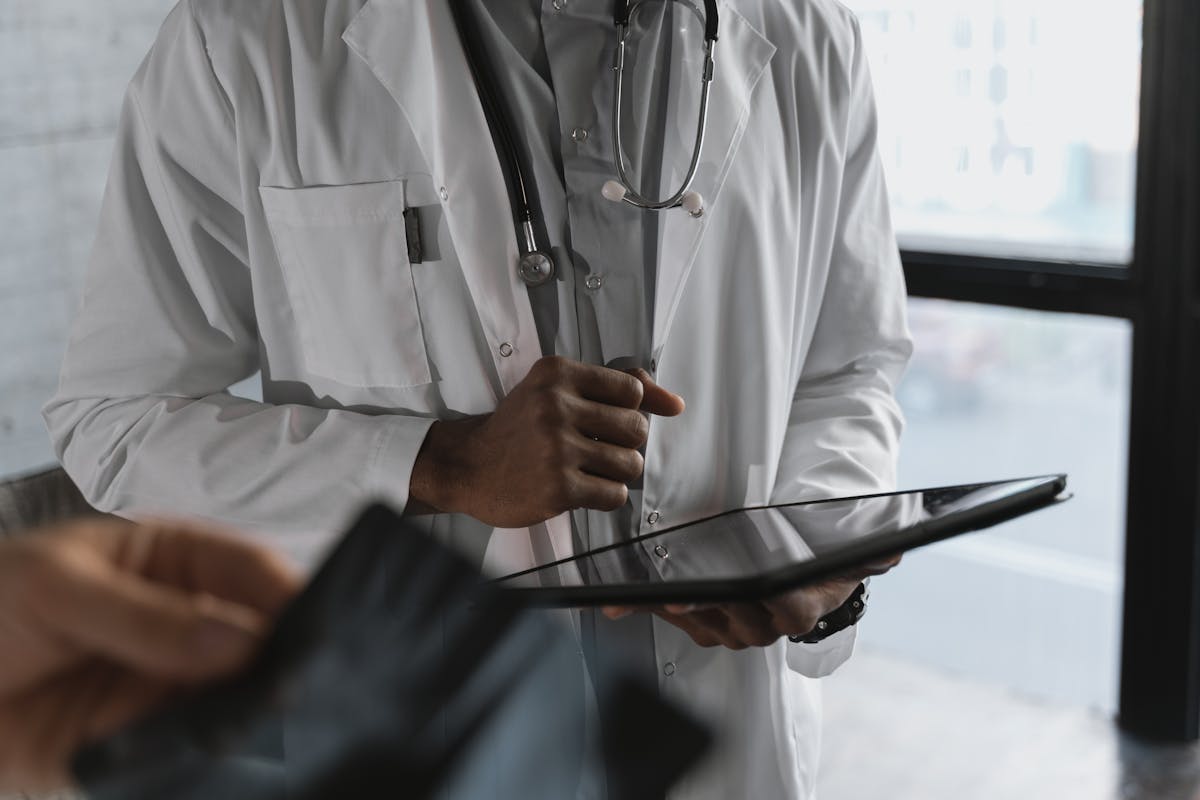 7 Reasons Hantavirus Could Become Worse Than COVID-19 3 A professional medical practitioner holding a tablet, focused on work in a clinical setting.
