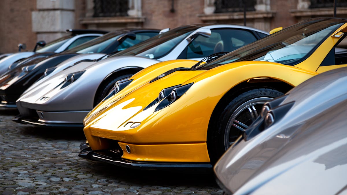 A stunning lineup of luxury sports cars captured outdoors showcasing elegant design and style.