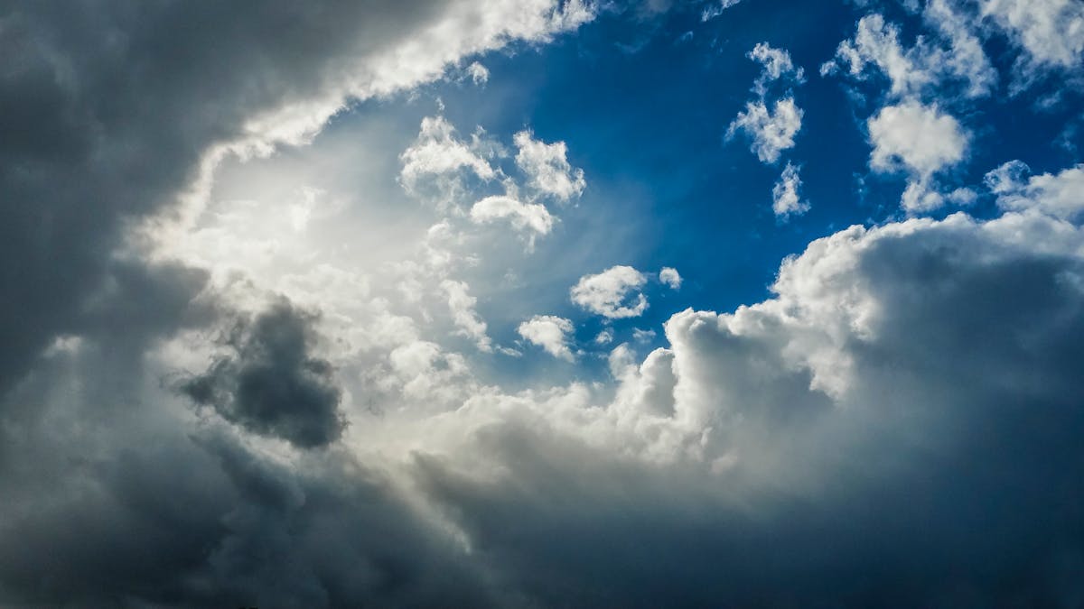 A stunning view of dramatic clouds with a bright patch of blue sky breaking through.