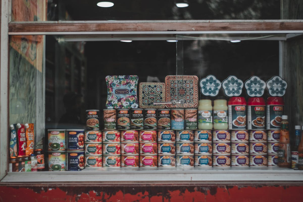 A vibrant selection of canned goods and condiments beautifully arranged in a store window.