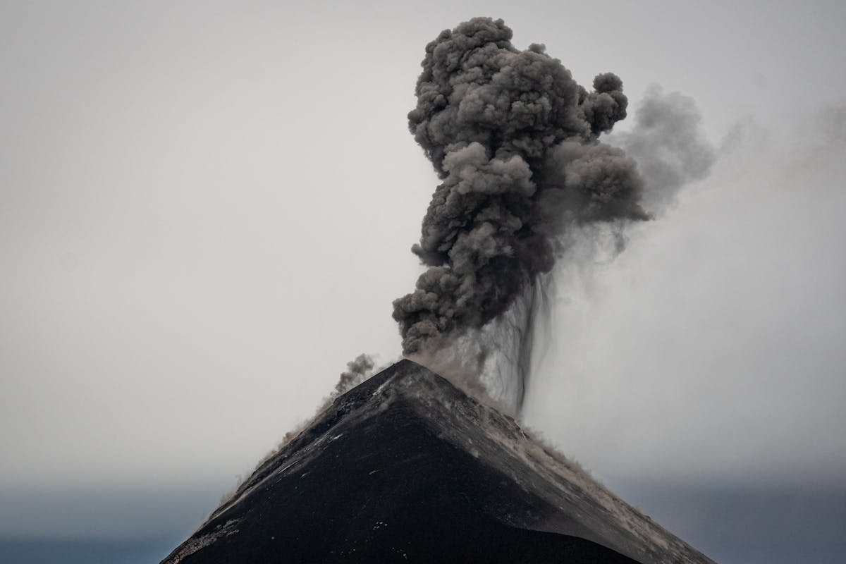 9 Explosive Volcano Facts That Reveal How Strange Earth’s Fire Mountains Really Are 2 Ash and smoke erupt from Acatenango volcano in Guatemala, capturing nature's raw power.