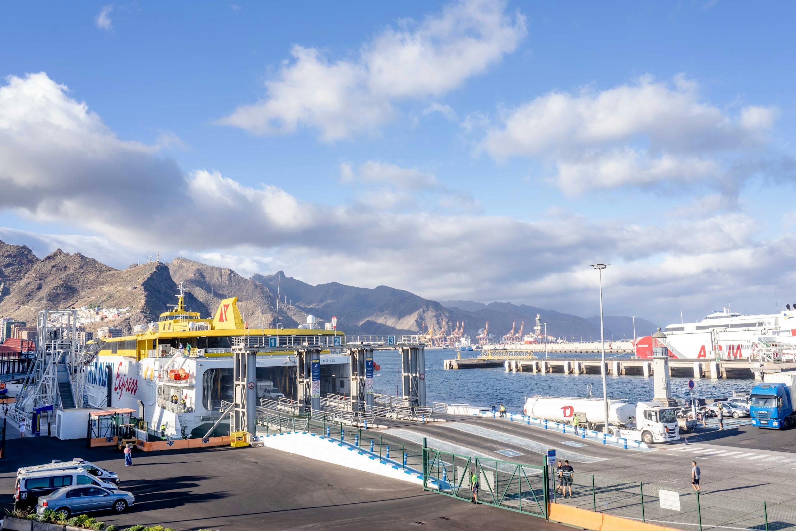 7 Chilling Lessons from the Hantavirus Cruise Ship Outbreak That Put Global Travel on Edge 3 Bustling Santa Cruz de Tenerife harbor showcasing ferries, mountains, and vibrant skies.