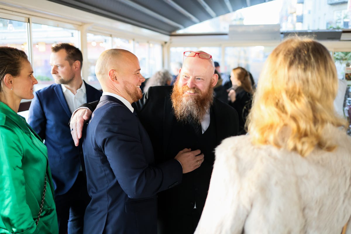 Candid scene of business professionals enjoying a jovial moment together indoors. Networking