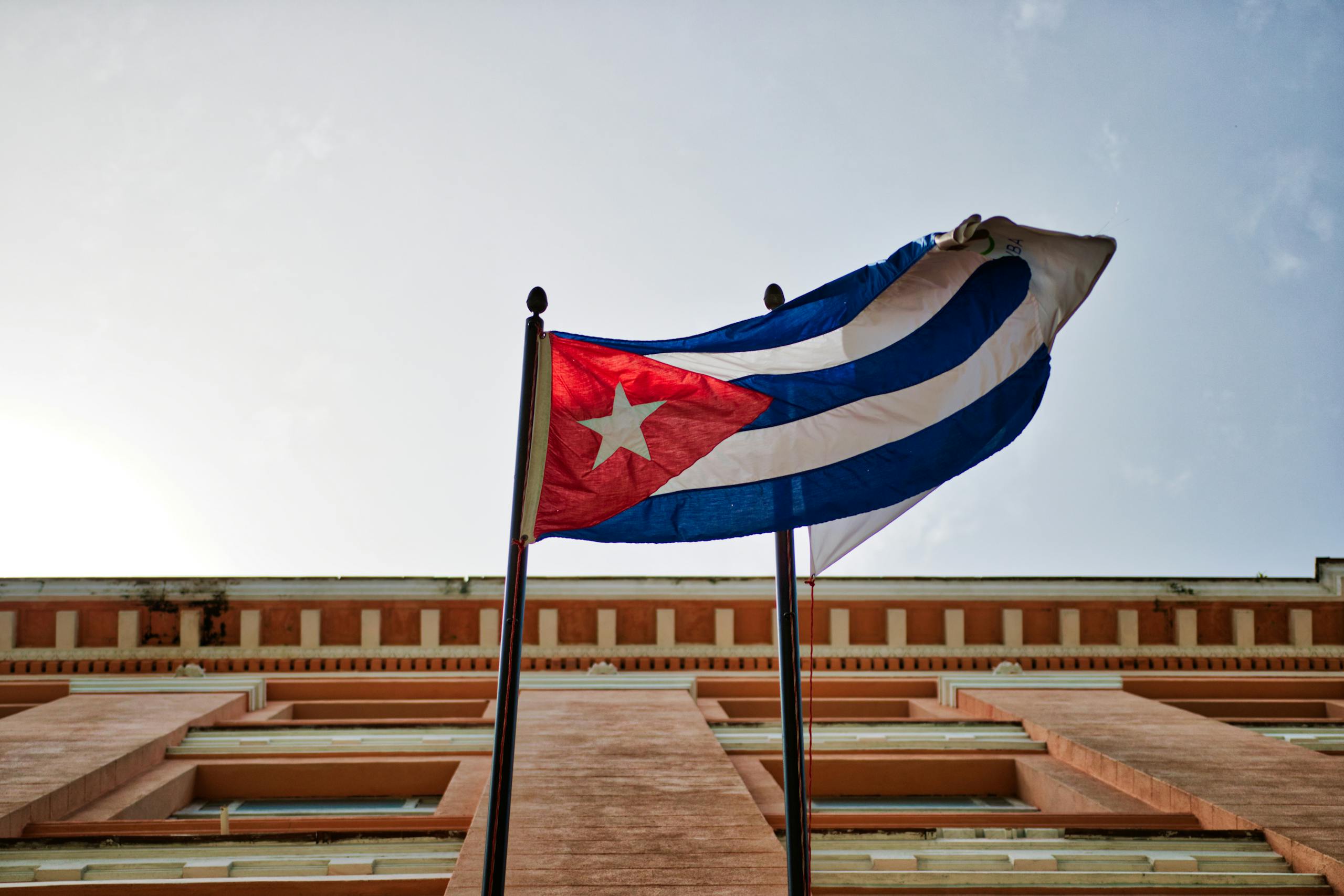 7 Ways Trump’s Feud With Pope Leo Turned Rubio’s Vatican Visit Into a Diplomatic Headache 3 Cuban flag waving against a historic building in Havana, capturing national pride and architectural beauty.