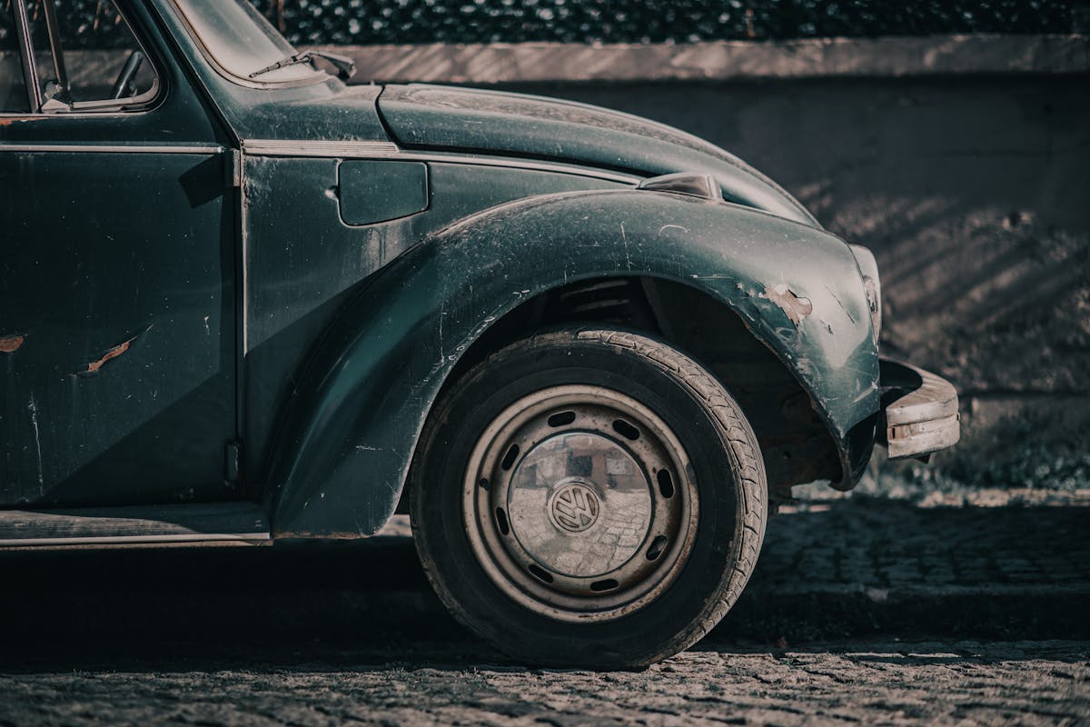 Detailed close-up of a rusted, classic Volkswagen Beetle showing vintage charm.