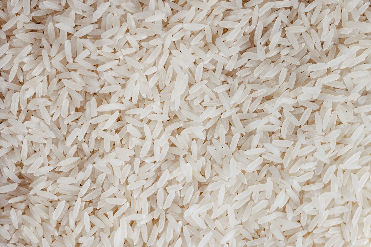 9 Common Foods That Could Be Riskier Than You Think 1 Detailed texture of uncooked white rice grains, perfect for food-related content.