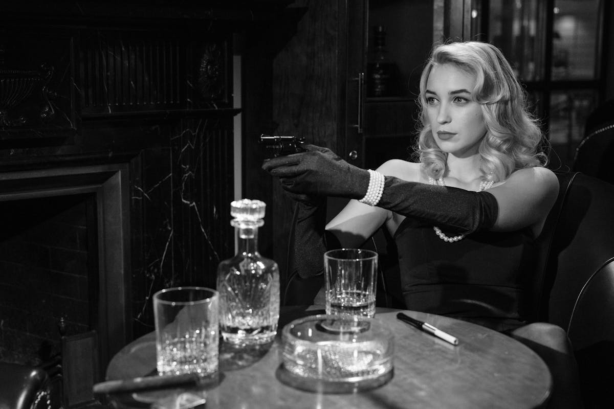 12 Rules Jesus Challenged in the Bible and Why They Still Matter Today 5 Elegant femme fatale holding a handgun, creating a vintage noir atmosphere indoors.