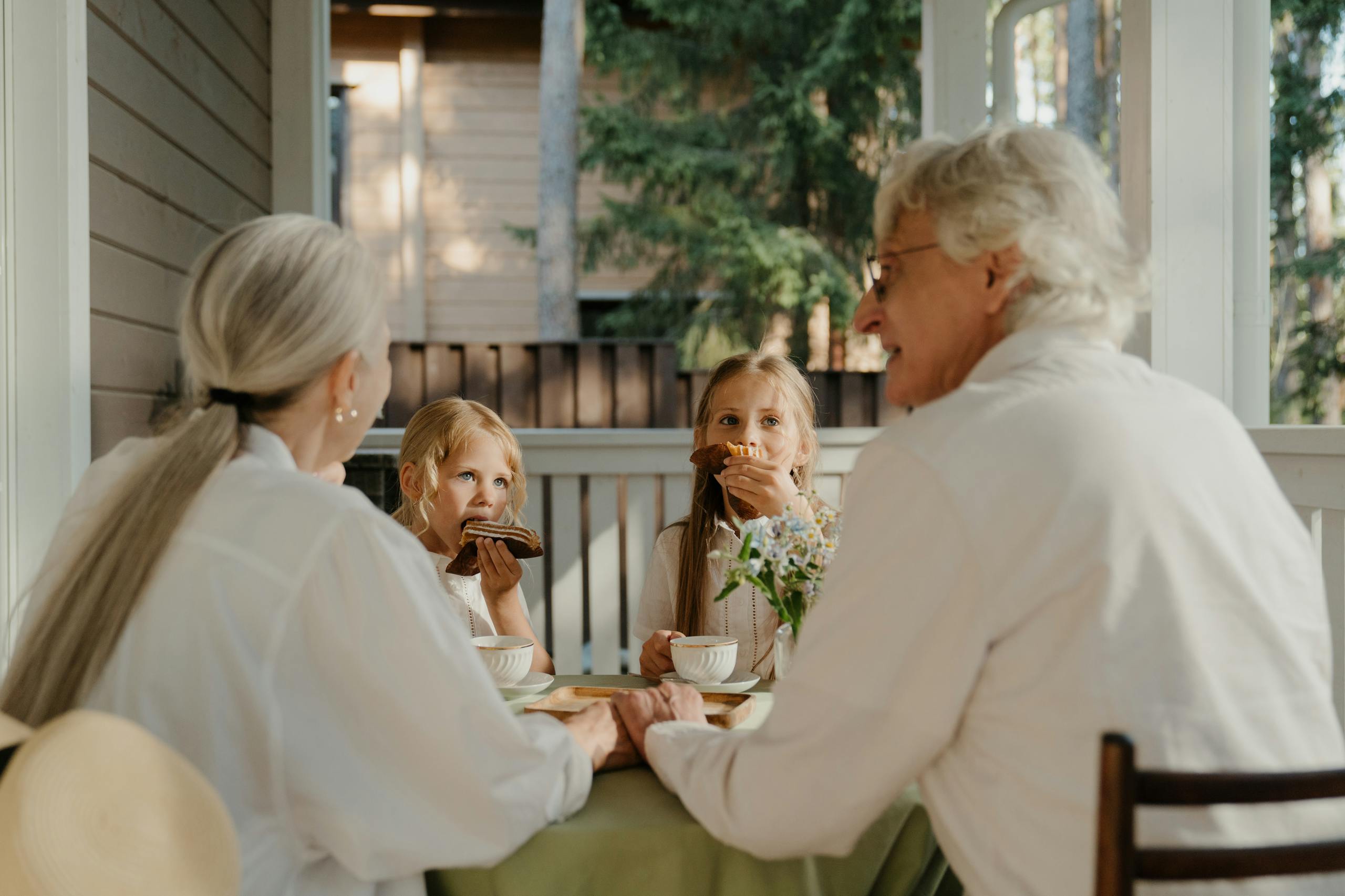 8 Shocking Ways Grandparents Are Becoming the New Childcare System 4 Grandparents enjoying quality time with their grandchildren at a patio table.