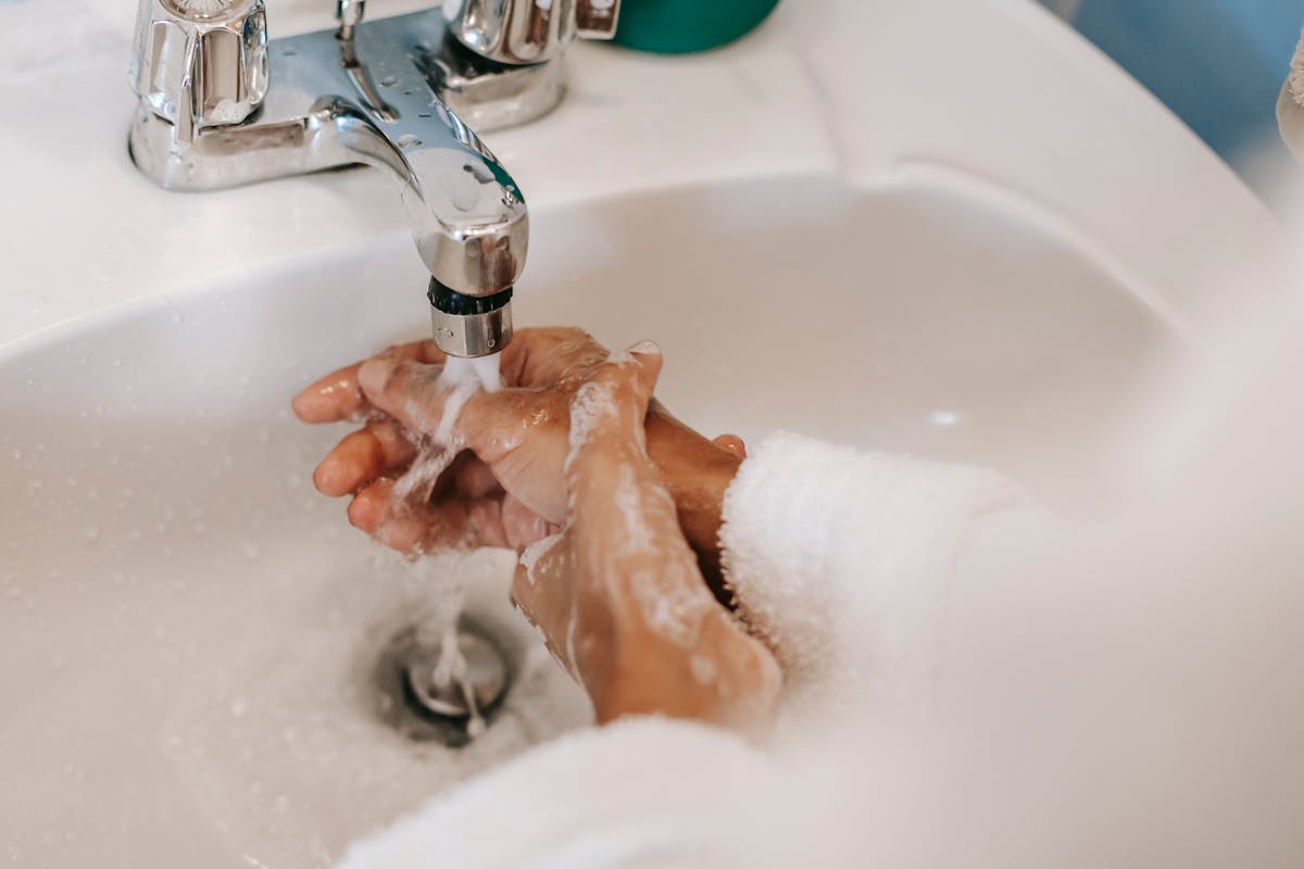 12 Things Women Find Unattractive in Men 2 High angle of crop anonymous ethnic female washing hands with foamy water during morning hygiene routine