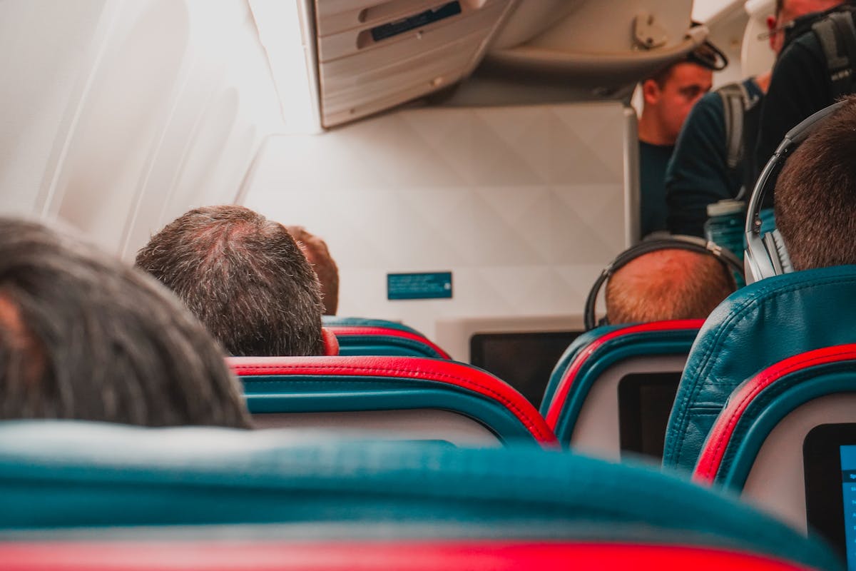 10 Major Travel Struggles and How We Can Make Every Trip Less Stressful 4 Interior view of an airplane cabin with passengers seated, focusing on seats and layout.
