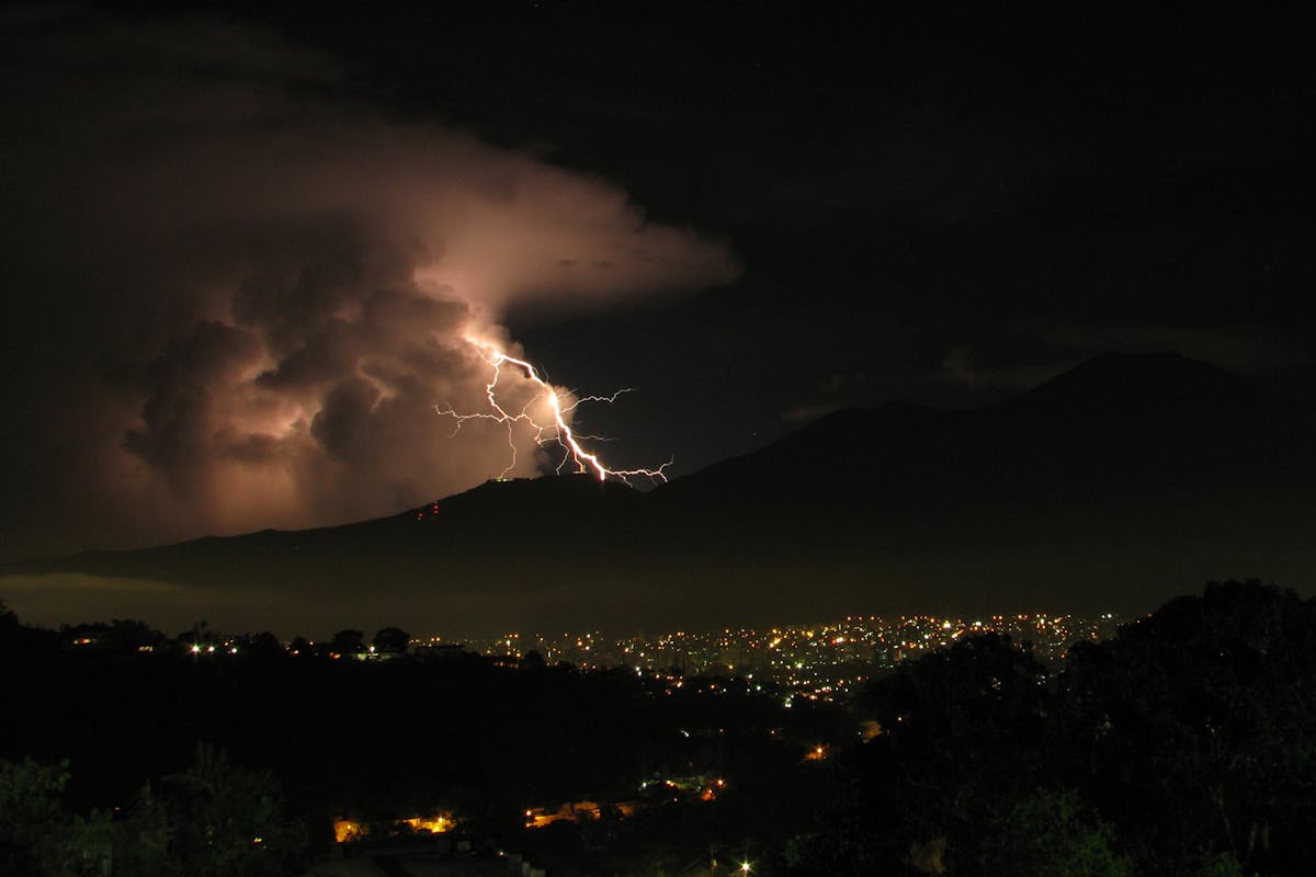 Planet in Peril: Experts warn 2026 Could Trigger Global Catastrophe 1 Lightning illuminates Caracas's night sky, capturing a striking cityscape under stormy clouds.