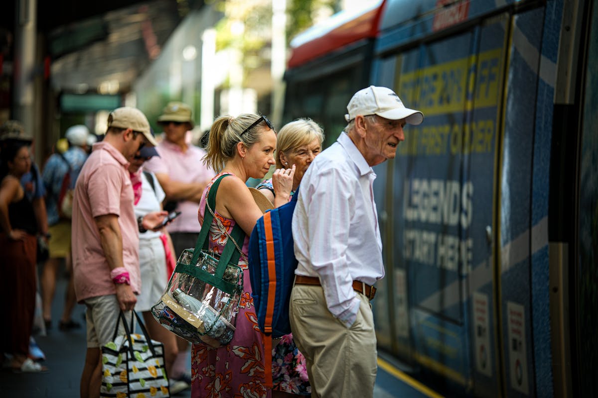 Warning Signs You’re Overly Frugal in Your Golden Years 3 People of various ages waiting at a train station in urban setting, capturing travel and commuting.