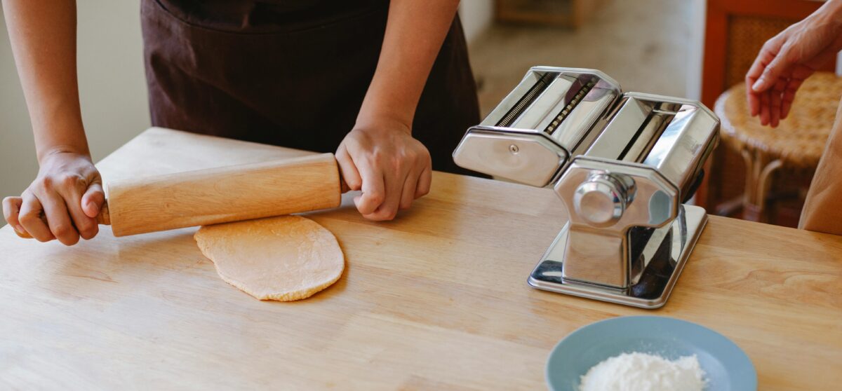 person-kneading-dough-with-a-rolling-pin