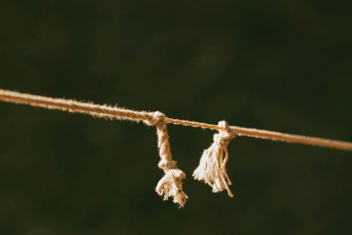 close-up-of-frayed-rope-on-green-background