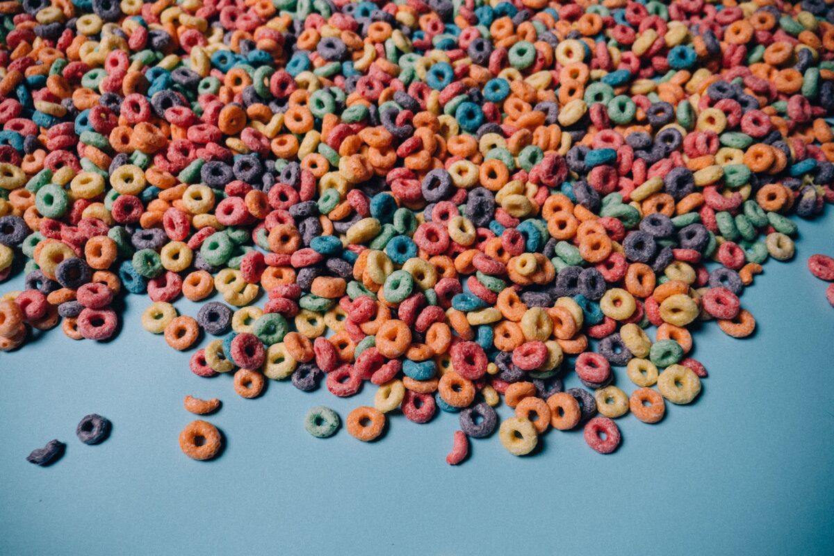 studio-shoot-of-multicoloured-cereals-against-blue-background