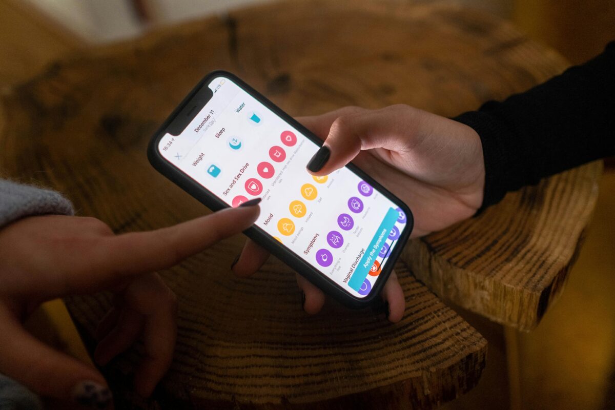 a-person-holding-a-smartphone-with-app-on-the-screen