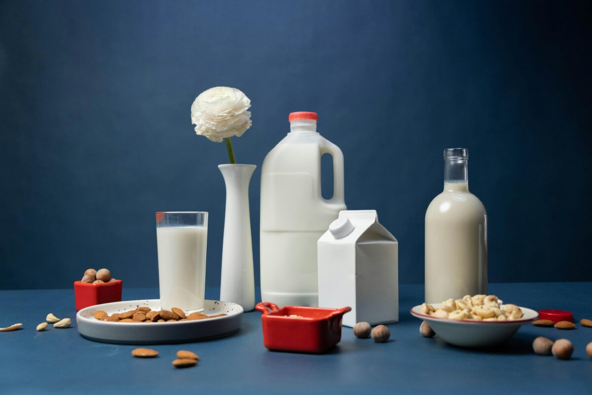 almond-and-hazelnut-milks-in-studio-on-blue-background