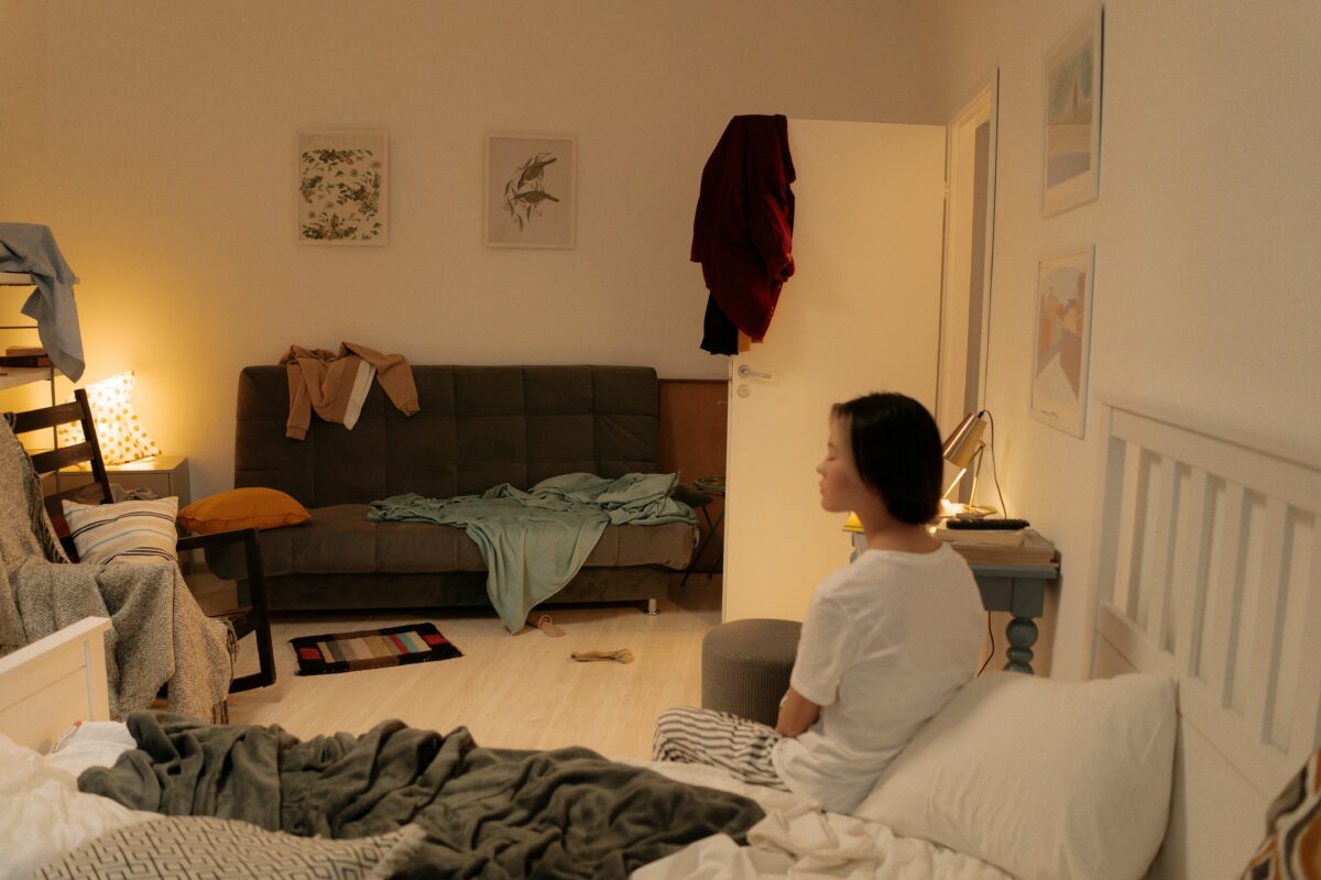 woman-in-white-shirt-sitting-on-bed